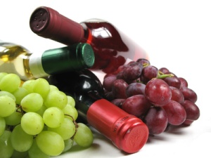 bottles of wine with grapes